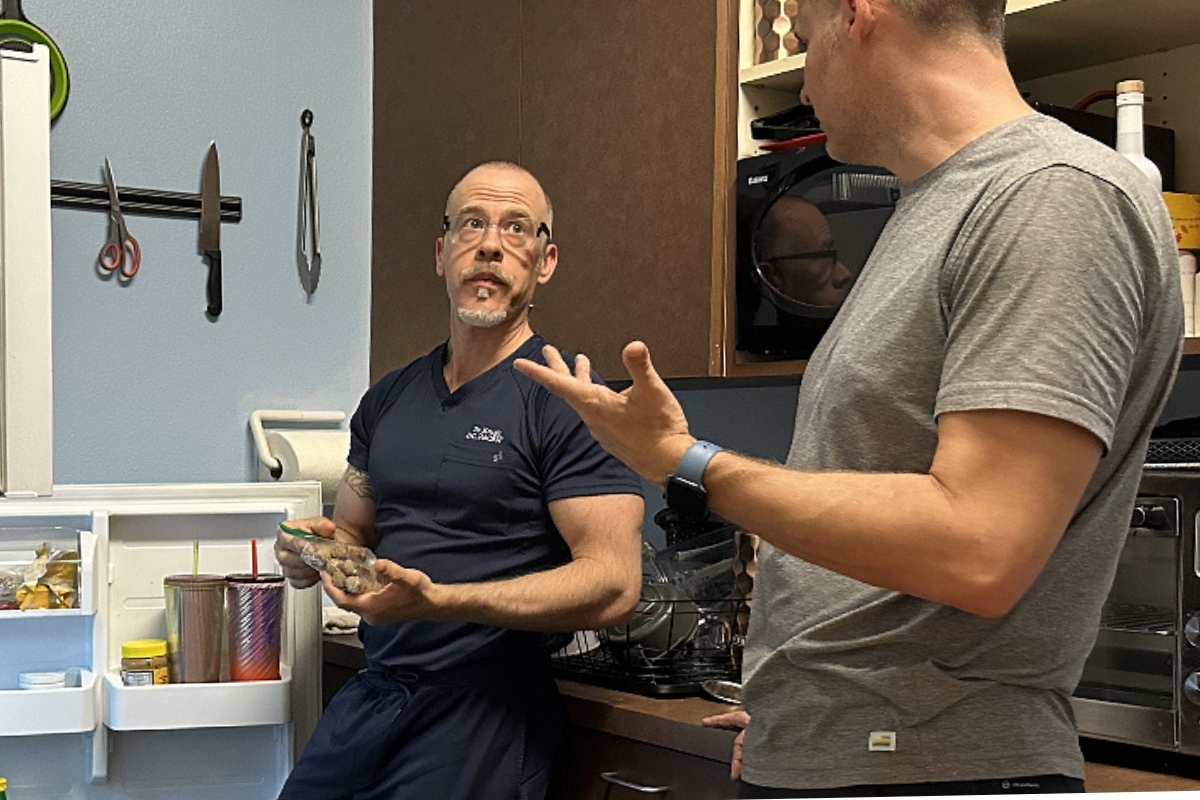nutrition (2) Dr K at Agape Health and FItness talking about nutrition with a patient as they stand in front of an open fridge